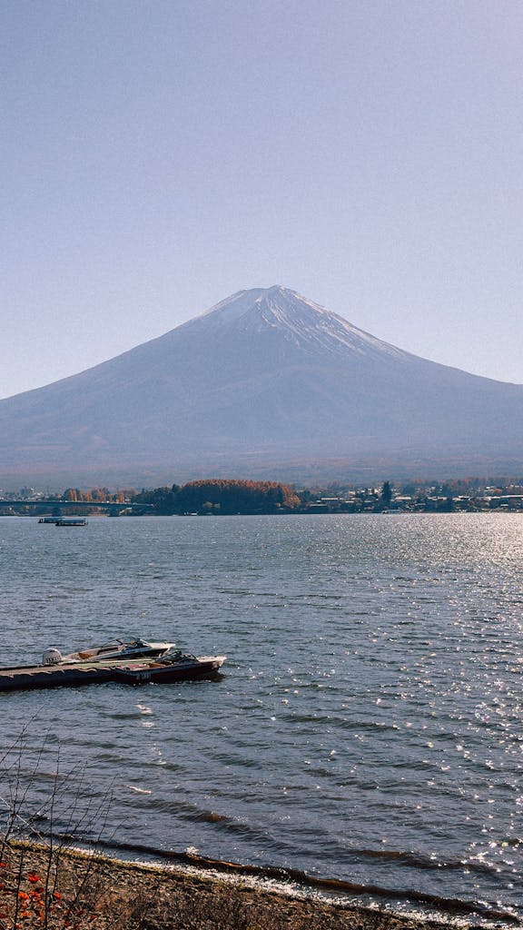 Beautiful view of Mount Fuji from Lake Kawaguchi with clear skies. Perfect for travel and nature enthusiasts.