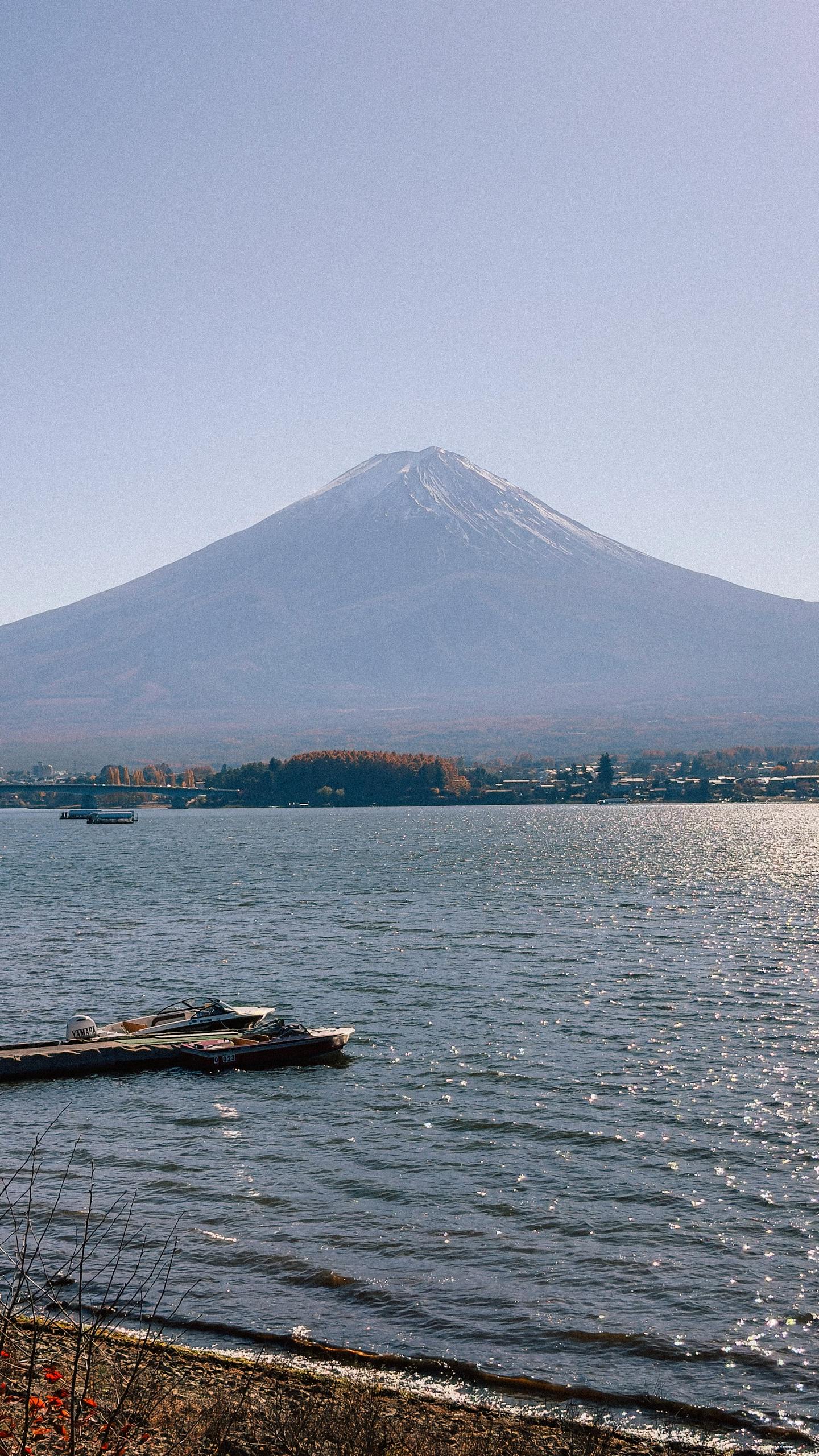 Beautiful view of Mount Fuji from Lake Kawaguchi with clear skies. Perfect for travel and nature enthusiasts.